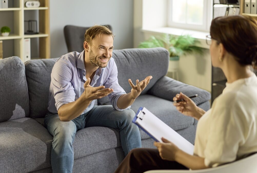 Man reflecting during a therapy session, working through intellectualizing emotions with a Burlington therapist