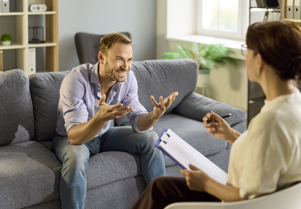 Man reflecting during a therapy session, working through intellectualizing emotions with a Burlington therapist